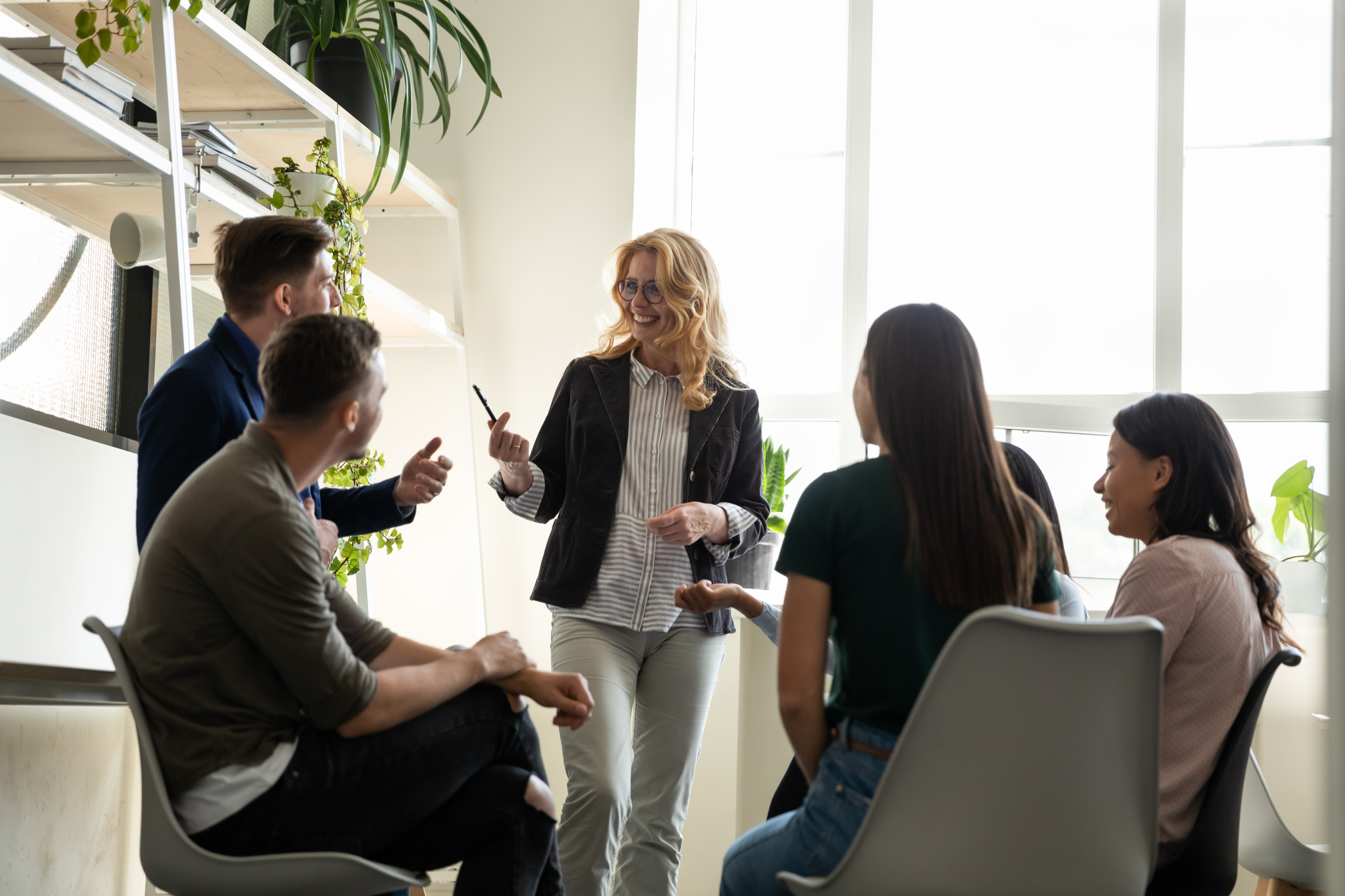 Businesslady and young multiracial staff taking part in corporate training